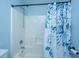 Bathtub shower combination featuring a blue floral shower curtain and chrome hardware at 1005 Trotters Blvd, Summerville, SC 29483