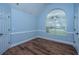 Bright bedroom with vaulted ceiling, modern wood flooring, and a large arched window at 1005 Trotters Blvd, Summerville, SC 29483