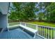 Relaxing deck area with built-in seating, surrounded by lush trees, perfect for outdoor entertaining at 1005 Trotters Blvd, Summerville, SC 29483
