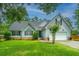 Charming one story home with mature landscaping, vinyl siding, and attached garage at 1005 Trotters Blvd, Summerville, SC 29483