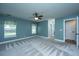 Spacious main bedroom with two windows, ceiling fan, and neutral carpet at 1005 Trotters Blvd, Summerville, SC 29483