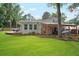 Lush backyard features a deck, grilling area, outdoor seating, boat storage and ample space at 1015 Jacksnipe Ln, Mount Pleasant, SC 29464