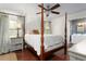 Elegant bedroom features a four-poster bed, hardwood floors, and natural light, creating a serene retreat at 1015 Jacksnipe Ln, Mount Pleasant, SC 29464