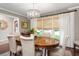 Inviting dining room featuring an oval table, six chairs, wood floors, and a large window at 1015 Jacksnipe Ln, Mount Pleasant, SC 29464