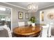 Dining room featuring a wood table with white chairs, modern lighting, and stylish decorations at 1015 Jacksnipe Ln, Mount Pleasant, SC 29464