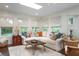Comfortable living room with large windows, hardwood floors, paneled walls, and a neutral sectional sofa at 1015 Jacksnipe Ln, Mount Pleasant, SC 29464