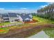 A view of the backyard, featuring a well-maintained lawn, privacy fence, and serene pond, creating a private outdoor oasis at 1059 Fitzgerald Ct, Summerville, SC 29485