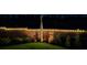 Night view of a beautifully landscaped backyard with string lights on the fence, creating a magical outdoor ambiance at 1059 Fitzgerald Ct, Summerville, SC 29485