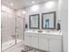 Bathroom featuring double sinks, white cabinetry, a tiled shower, and modern fixtures at 1059 Fitzgerald Ct, Summerville, SC 29485