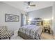 Cozy bedroom with patterned bedding, ceiling fan, and stylish decorations, offering a relaxing retreat at 1059 Fitzgerald Ct, Summerville, SC 29485