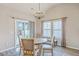 Dining area features a round table, modern chandelier, large windows, and access to the backyard at 1059 Fitzgerald Ct, Summerville, SC 29485