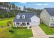 Charming home with a welcoming front porch, manicured lawn, and two-car garage at 1059 Fitzgerald Ct, Summerville, SC 29485