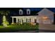 Charming home exterior at night featuring a well-lit porch, manicured lawn, and inviting curb appeal at 1059 Fitzgerald Ct, Summerville, SC 29485