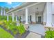 Inviting front porch with stone accents, comfortable seating, and tasteful landscaping, creating a warm entryway at 1059 Fitzgerald Ct, Summerville, SC 29485