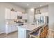 Modern kitchen equipped with white cabinets, stainless steel appliances, and a large island with seating, perfect for cooking at 1059 Fitzgerald Ct, Summerville, SC 29485