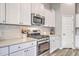 Modern kitchen features stainless steel appliances, white cabinets, and subway tile backsplash at 1059 Fitzgerald Ct, Summerville, SC 29485