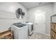Organized laundry room with modern appliances, storage shelves, and ample space for chores at 1059 Fitzgerald Ct, Summerville, SC 29485
