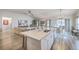 Open floor plan from kitchen to living room, with island seating and stainless appliances at 1059 Fitzgerald Ct, Summerville, SC 29485