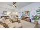 Bright living room with a large sectional, stylish decor, and a fireplace, offering a comfortable space for relaxation at 1059 Fitzgerald Ct, Summerville, SC 29485
