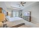 Cozy bedroom with neutral colors, tray ceilings, a ceiling fan, and large windows with natural light at 1059 Fitzgerald Ct, Summerville, SC 29485