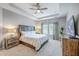 Bright bedroom features tray ceilings, a ceiling fan, and large windows with natural light at 1059 Fitzgerald Ct, Summerville, SC 29485