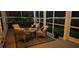 Cozy screened porch with comfortable seating, a stylish rug, and soft lighting, creating a relaxing outdoor space at 1059 Fitzgerald Ct, Summerville, SC 29485