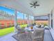 Inviting screened porch with comfortable seating, ceiling fan, and a view of the lush backyard at 1059 Fitzgerald Ct, Summerville, SC 29485