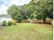 Large grassy backyard with a privacy fence and outdoor seating at 1077 Farmington Rd, Charleston, SC 29412