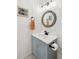 Charming powder room featuring a blue vanity and decorative round mirror at 1077 Farmington Rd, Charleston, SC 29412
