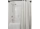 All white bathtub and shower combination with a white shower curtain at 1077 Farmington Rd, Charleston, SC 29412