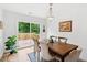 Bright dining room features a wooden table, stylish chairs, and sliding glass doors to the deck at 1077 Farmington Rd, Charleston, SC 29412
