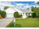 Charming single-story home with a well-manicured lawn, white siding, and an attached garage at 1077 Farmington Rd, Charleston, SC 29412