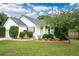 Charming single-story home with manicured landscaping, white siding and a welcoming front porch at 1077 Farmington Rd, Charleston, SC 29412