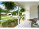 Cozy front porch view showcasing ferns, seating, and neighborhood scenery at 1077 Farmington Rd, Charleston, SC 29412