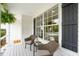 Charming front porch with wicker seating and hanging ferns, perfect for relaxing at 1077 Farmington Rd, Charleston, SC 29412