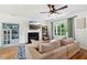 Bright living room featuring a fireplace, ceiling fan, and a large window at 1077 Farmington Rd, Charleston, SC 29412