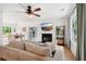 Bright living room featuring a fireplace, ceiling fan, and a view of the dining room at 1077 Farmington Rd, Charleston, SC 29412