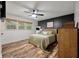 Bedroom featuring hardwood floors, a queen bed, and three windows at 109 Lakeview Dr, Summerville, SC 29485