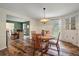 Bright dining room with wood-look flooring, a round table with seating for four, and an open view to the office at 109 Lakeview Dr, Summerville, SC 29485