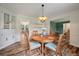 Dining room featuring wood-look floors, a round table with seating for four, and built-in cabinetry at 109 Lakeview Dr, Summerville, SC 29485