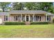 Charming brick ranch-style home with a welcoming front porch, manicured lawn, and lush landscaping at 109 Lakeview Dr, Summerville, SC 29485
