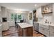 An open kitchen features a kitchen island, stainless steel appliances, white cabinetry, and a breakfast nook at 109 Lakeview Dr, Summerville, SC 29485