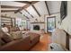 Welcoming living room with exposed wood beams, hardwood floors, a brick fireplace, and comfortable seating at 109 Lakeview Dr, Summerville, SC 29485