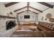 Inviting living room with a brick fireplace, wood beams, a comfortable leather sofa, and a wooden floor at 109 Lakeview Dr, Summerville, SC 29485