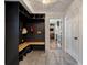 Mudroom with built-in storage bench, black wainscoting, and tile floors at 109 Lakeview Dr, Summerville, SC 29485