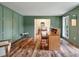 Stylish office with wood-look floors, green walls with millwork, and views to the foyer at 109 Lakeview Dr, Summerville, SC 29485