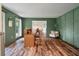 Bright office with wood floors, green accent wall, and open to the dining area at 109 Lakeview Dr, Summerville, SC 29485