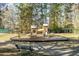 Wood playground area featuring slides, climbing structures, and swings at 109 Lakeview Dr, Summerville, SC 29485