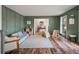 Spacious playroom featuring wood-look flooring, green walls with paneling, and views to the foyer at 109 Lakeview Dr, Summerville, SC 29485
