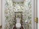 Stylish powder room with tropical-themed wallpaper and new fixtures. Ample space for storage at 109 Lakeview Dr, Summerville, SC 29485